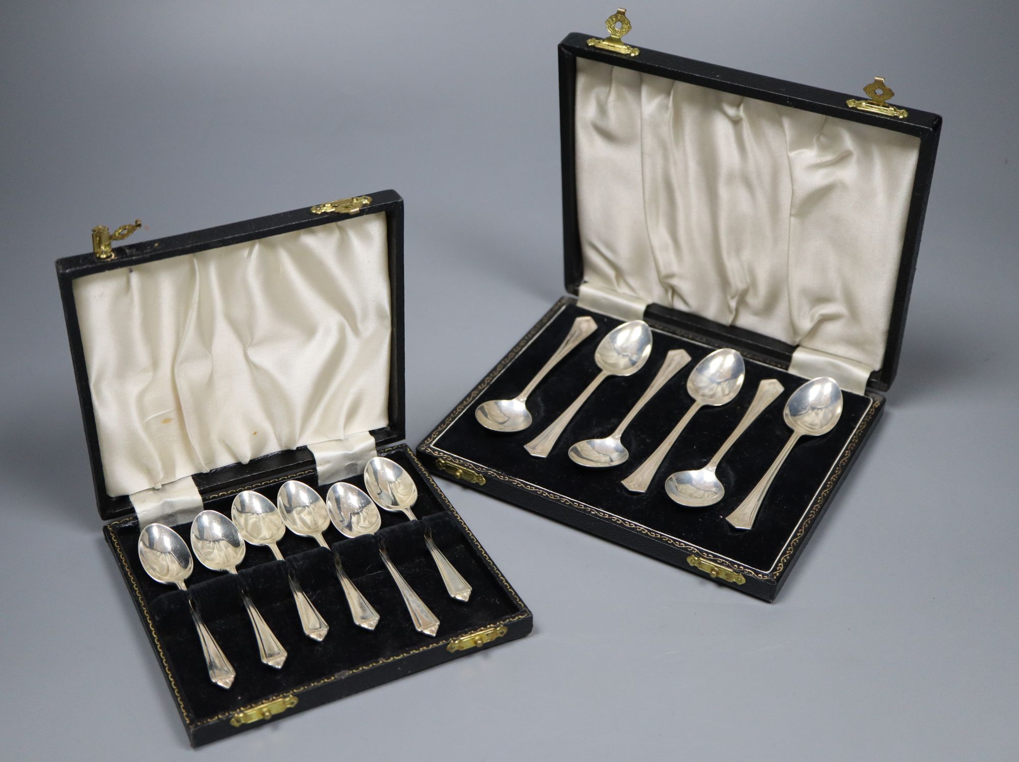 A cased set of six mid 20th century silver teaspoons and six similar coffee spoons.